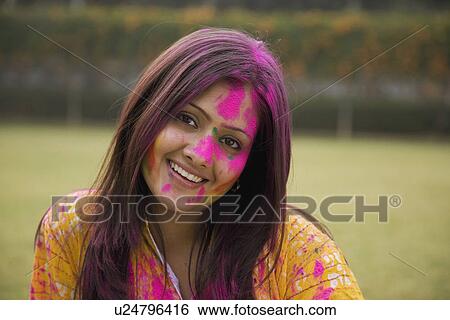 Girl's face covered with gulal View Large Photo Image Stock Photograph - Girl's face covered with gulal. Fotosearch