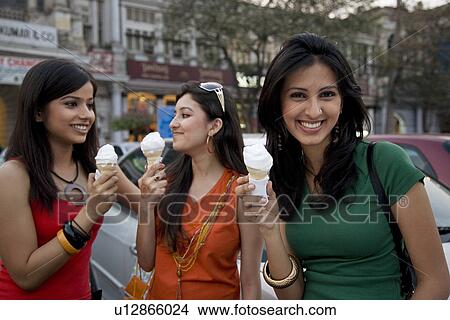 Picture - Girls having ice-cream. Fotosearch