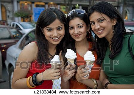 Girls holding ice-cream cones View Large Photo Image Picture - Girls holding ice-cream cones. Fotosearch