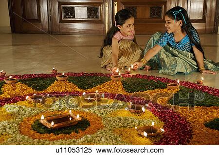 Girls placing diyas View Large Photo Image Stock Photography - Girls placing diyas. Fotosearch