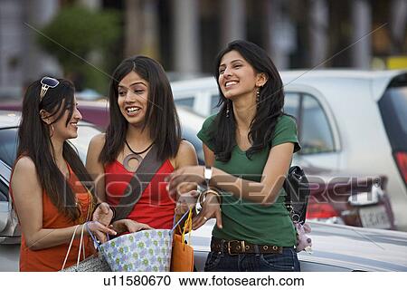 Stock Image - Girls standing in the parking area. Fotosearch
