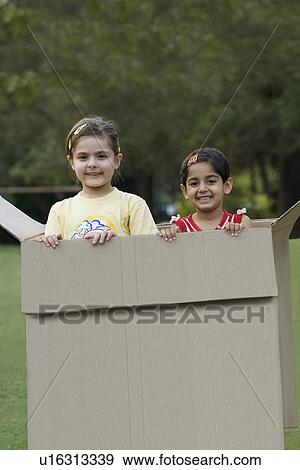 Stock Photo - Girls standing inside a box. Fotosearch