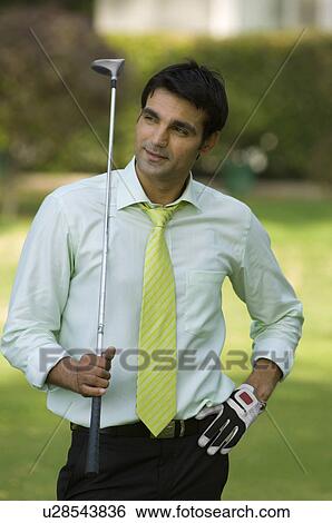 Golf player standing in golf course View Large Photo Image Stock Photograph - Golf player standing in golf course. Fotosearch