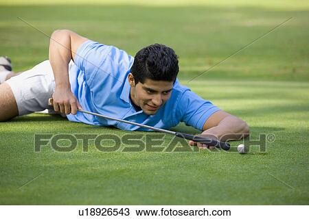 Stock Image - Golfer about to shoot. Fotosearch