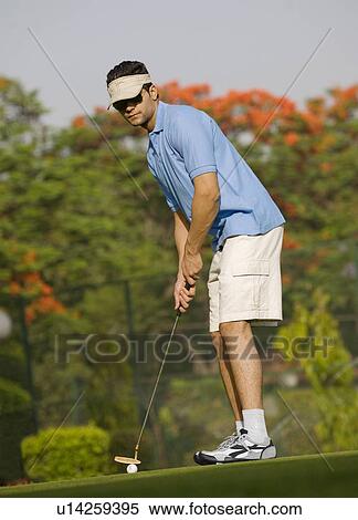 Stock Photography - Golfer about to strike. Fotosearch