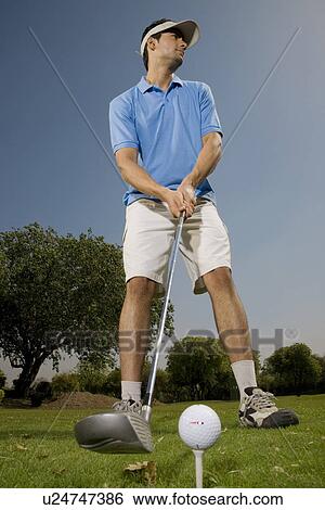 Golfer about to tee off View Large Photo Image Stock Photograph - Golfer about to tee off. Fotosearch