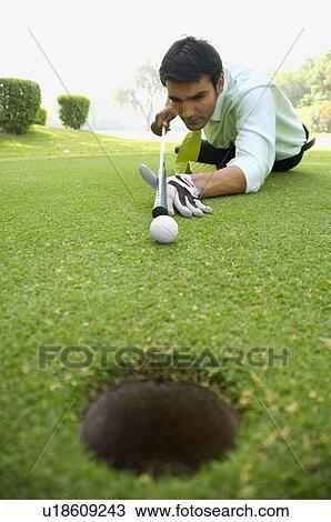 Golfer putting View Large Photo Image Stock Image - Golfer putting. Fotosearch