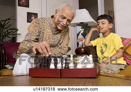 Stock Photo - Grandfather playing with grandson. Fotosearch
