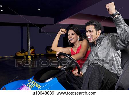 Stock Photo - Having fun in bumper cars. Fotosearch