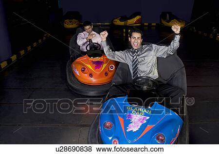 Stock Photo - Having fun in bumper cars. Fotosearch