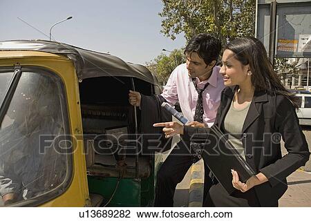 Stock Image - Hiring an auto rickshaw. Fotosearch