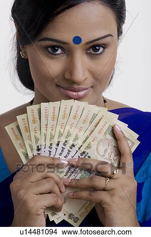 Picture - Holding some money. Fotosearch