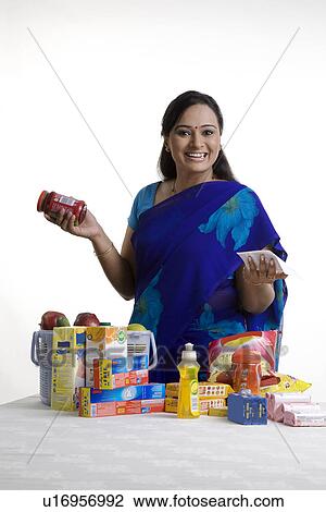Stock Image - House wife checking her shopping. Fotosearch
