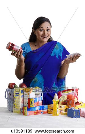 Stock Photo - House wife checking her shopping. Fotosearch