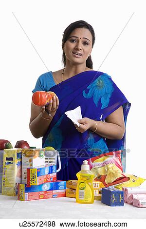 Stock Photo - House wife checking her shopping. Fotosearch