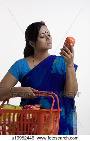 Stock Photograph - House wife checking her shopping. Fotosearch