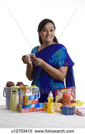 Stock Photography - House wife checking her shopping. Fotosearch