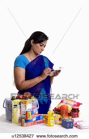 Stock Photo - Housewife checking the bill. Fotosearch