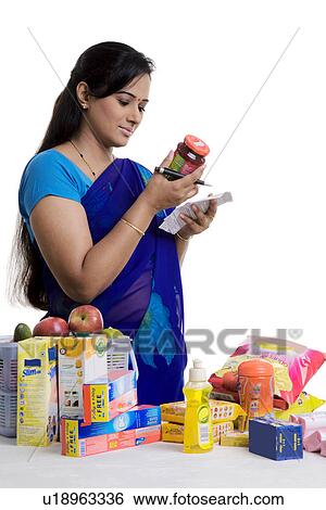 Stock Photograph - Housewife checking the bill. Fotosearch