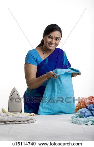Housewife ironing clothes View Large Photo Image Stock Image - Housewife ironing clothes. Fotosearch
