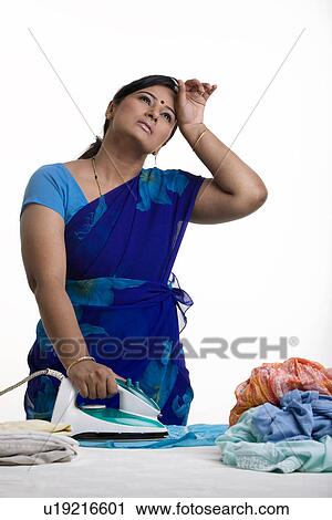 Housewife ironing clothes View Large Photo Image Stock Image - Housewife ironing clothes. Fotosearch