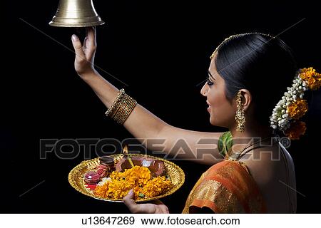 Stock Photo - Indian woman performing puja. Fotosearch
