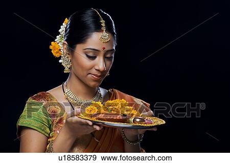 Stock Photo - Indian woman performing puja. Fotosearch