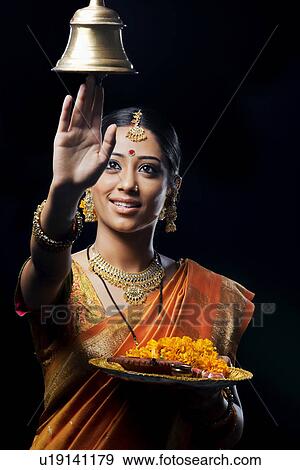 Indian woman performing puja View Large Photo Image Stock Photo - Indian woman performing puja. Fotosearch
