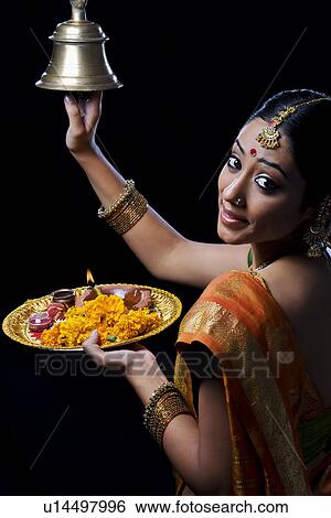 Indian woman performing puja View Large Photo Image Stock Photograph - Indian woman performing puja. Fotosearch