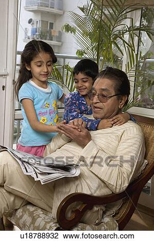 Stock Image - Kids with their grandfather. Fotosearch