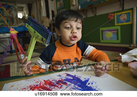 Stock Photo - Little boy painting. Fotosearch