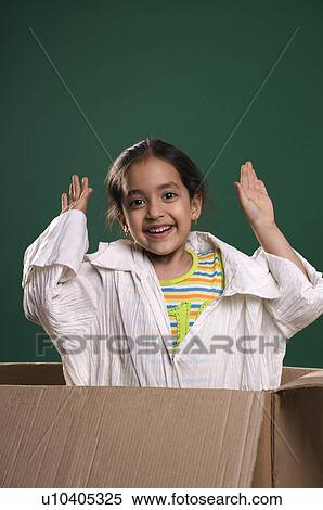 Stock Photography - Little girl in a cardboard box. Fotosearch