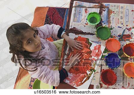 Stock Photograph - Little girl painting. Fotosearch