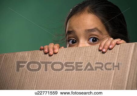 Little girl peeking from cardboard box View Large Photo Image Stock Photo - Little girl peeking from cardboard box. Fotosearch