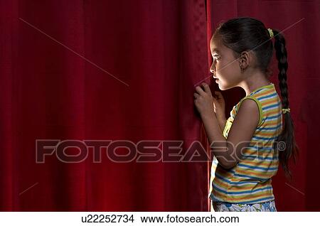 Little girl peeking out from behind the curtain View Large Photo Image Picture - Little girl peeking out from behind the curtain. Fotosearch