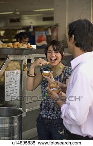 Man and woman having street food View Large Photo Image Stock Photography - Man and woman having street food. Fotosearch