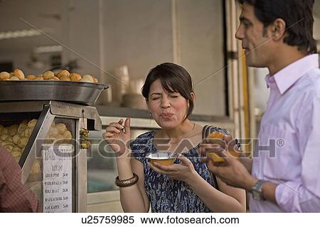 Man and woman having street food View Large Photo Image Stock Photography - Man and woman having street food. Fotosearch