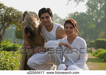 Man and woman with a dog View Large Photo Image Stock Photo - Man and woman with a dog. Fotosearch