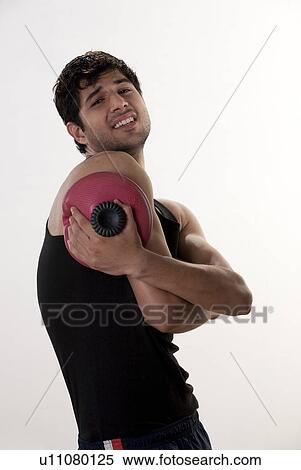 Stock Photography - Man applying a hot water bag. Fotosearch