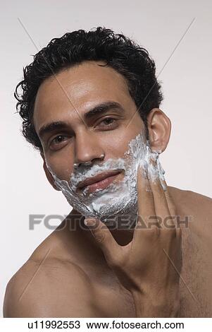 Man applying shaving cream on his face View Large Photo Image Stock Image - Man applying shaving cream on his face. Fotosearch