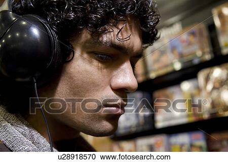 Stock Image - Man at a music store. Fotosearch