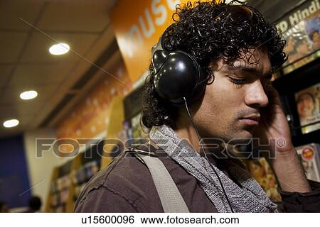 Stock Photograph - Man at a music store. Fotosearch