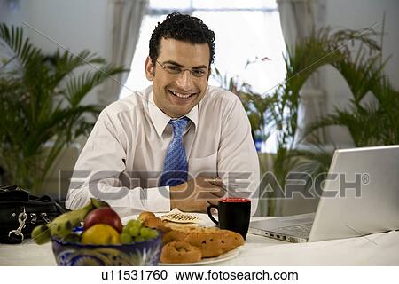 Stock Image - Man at the dining table. Fotosearch