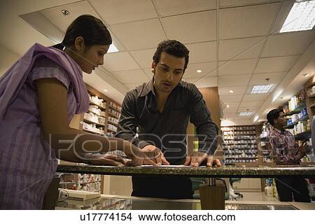 Picture - Man at the pharmacy. Fotosearch