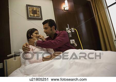 Stock Image - Man consoling his wife. Fotosearch