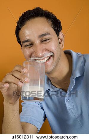 Man drinking a glass of milk View Large Photo Image Stock Image - Man drinking a glass of milk. Fotosearch