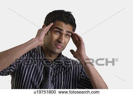 Stock Image - Man having a headache. Fotosearch