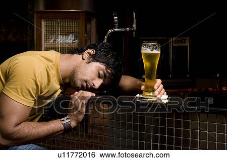 Man holding a glass of beer View Large Photo Image Stock Photograph - Man holding a glass of beer. Fotosearch