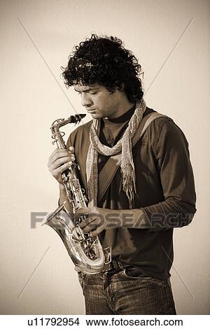 Picture - Man holding a saxophone. Fotosearch
