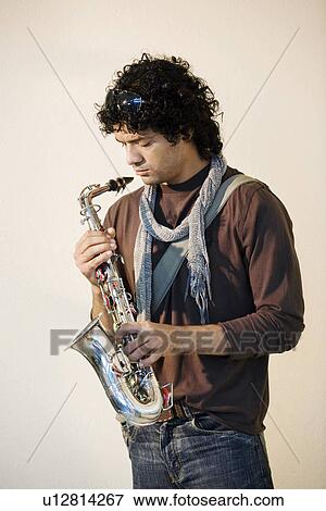 Stock Photo - Man holding a saxophone. Fotosearch